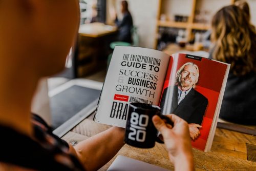 man-reading-a-book-on-business-growth-and-success-by-richard-branson