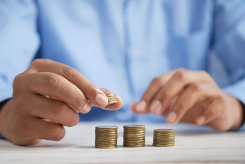 person-stacking-coins-on-top-of-each-other