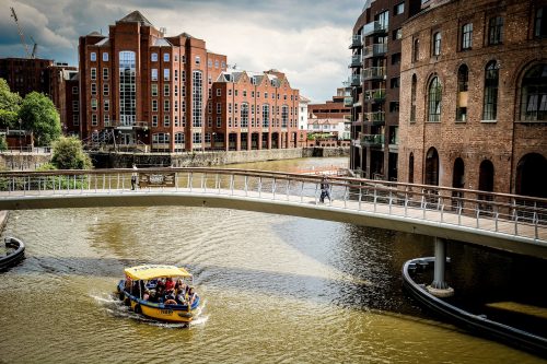 shot-of-bristol-harbour-with-boat-sailing-and-a-bridge