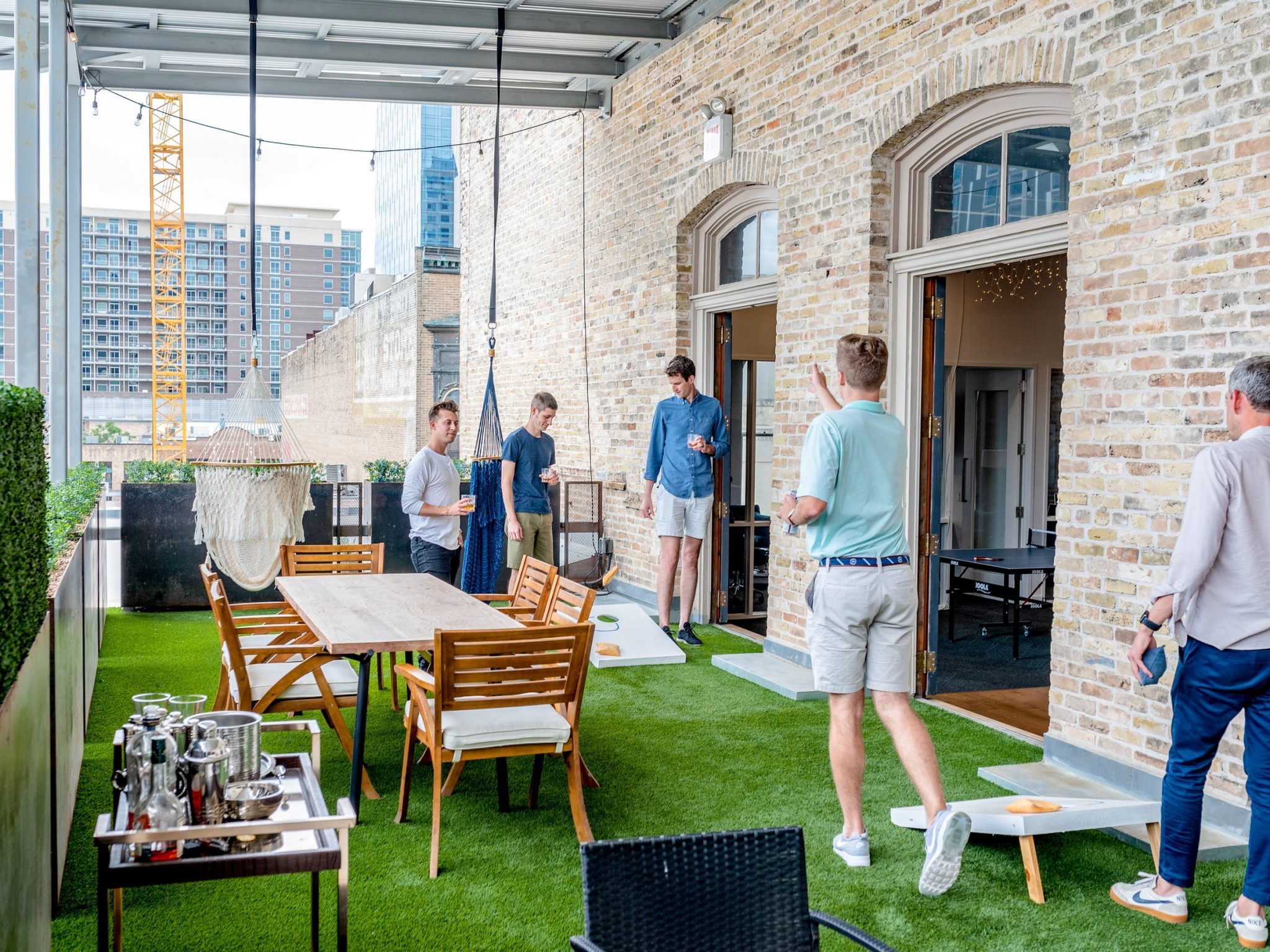 team-of-employees-enjoying-a-game-at-work-whilst-having-a-drink