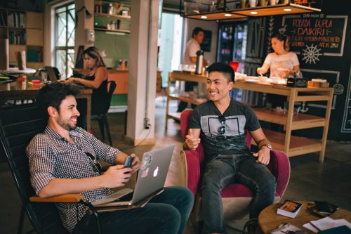 two-men-collaborating-in-chairs-and-smiling