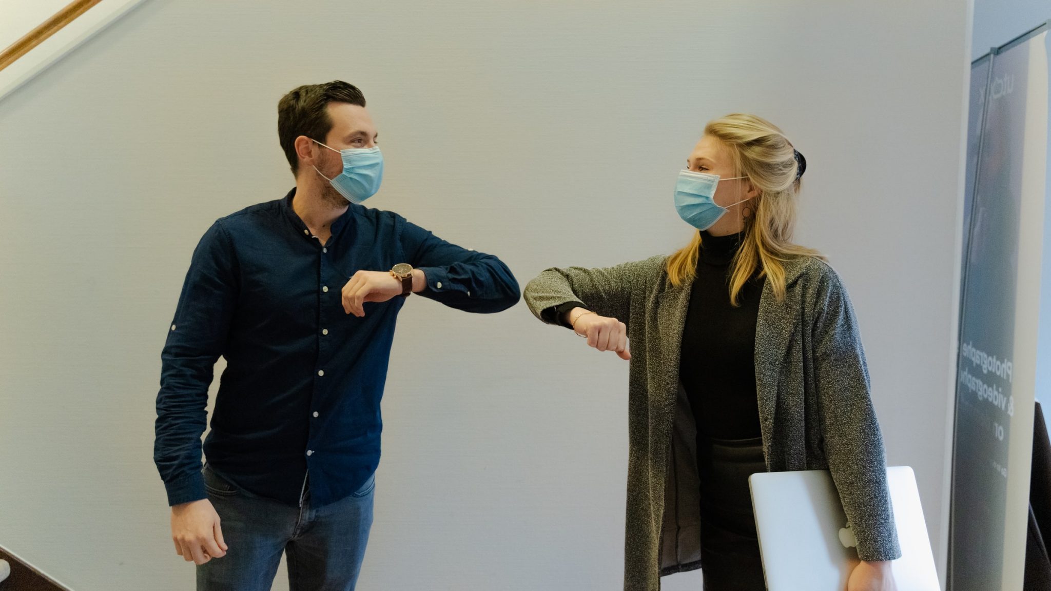 two-people-bumping-elbows-with-face-masks-on