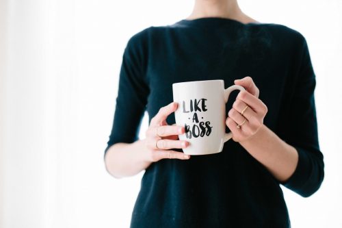woman-holding-coffee-cup-that-says-like-a-boss