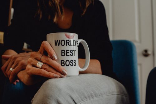 woman-holding-cup-that-says-worlds-best-boss