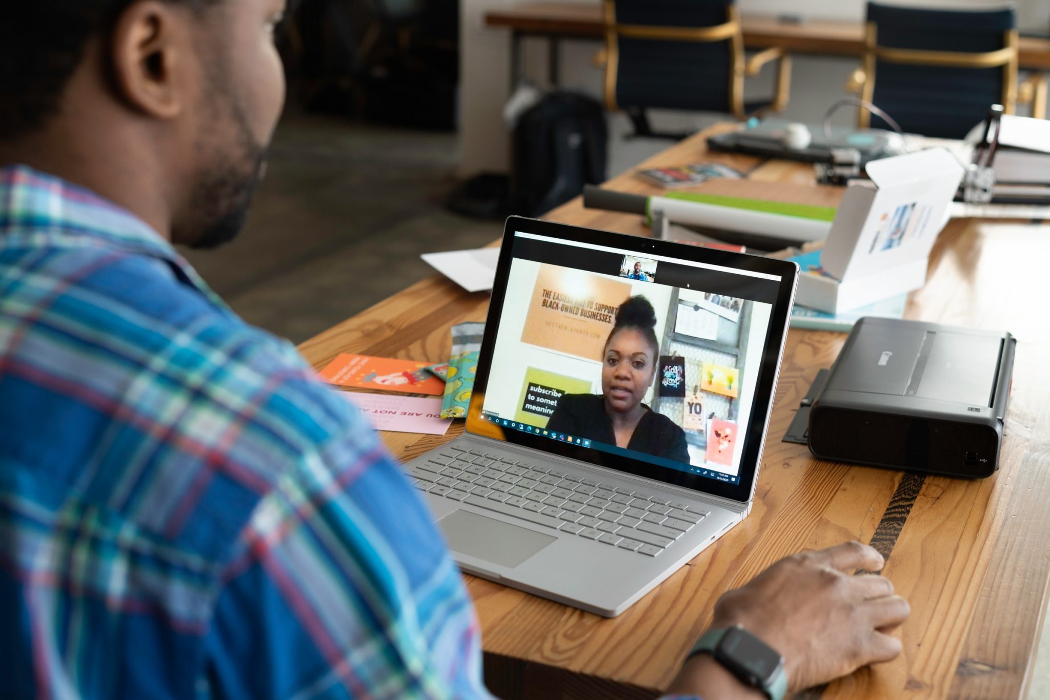 man-interviewing-woman-on-a-laptop