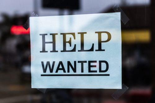 paper-sign-in-window-that-says-help-wanted
