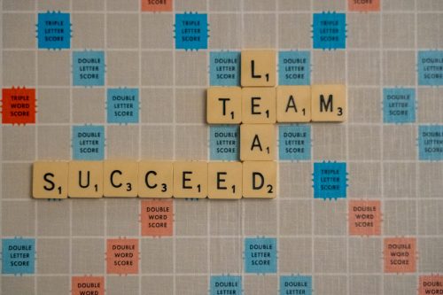 scrabble-board-with-the-words-lead-team-and-succeed-placed-upon-it-interlinking