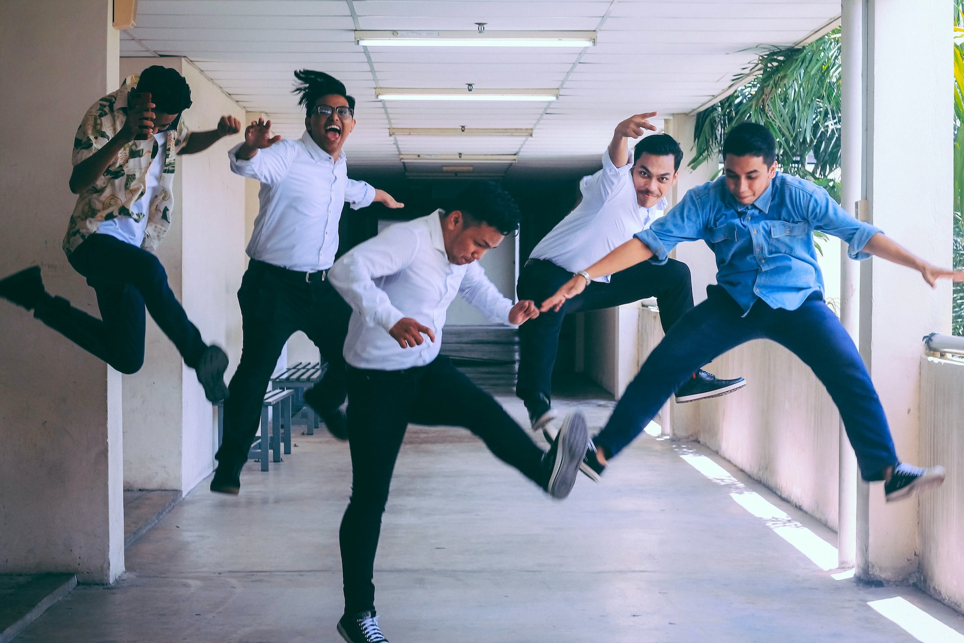 five-employees-jumping-for-joy-and-looking-happy