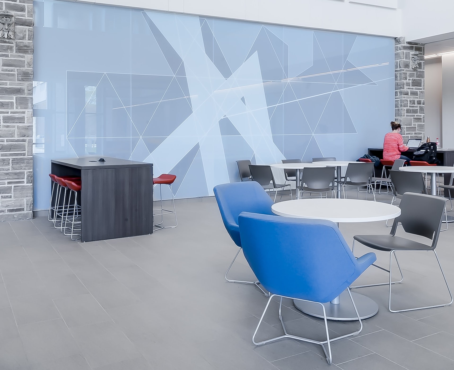 bright-office-space-area-with-blue-chairs-and-high-ceiling