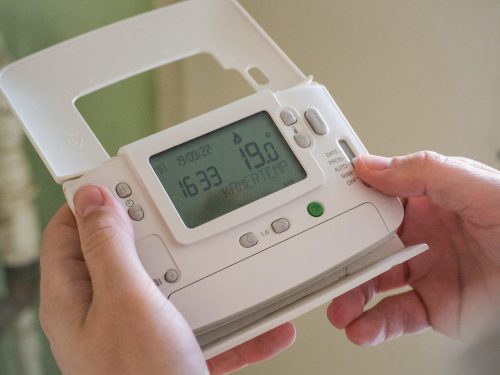 close-up-shot-of-someone-holding-a-smart-meter-analysing-their-energy-usage