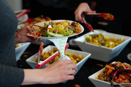 image-of-a-person-with-a-plate-of-food-in-an-office-meeting