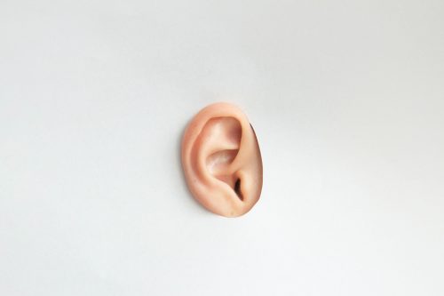 image-of-an-ear-poking-through-a-white-background