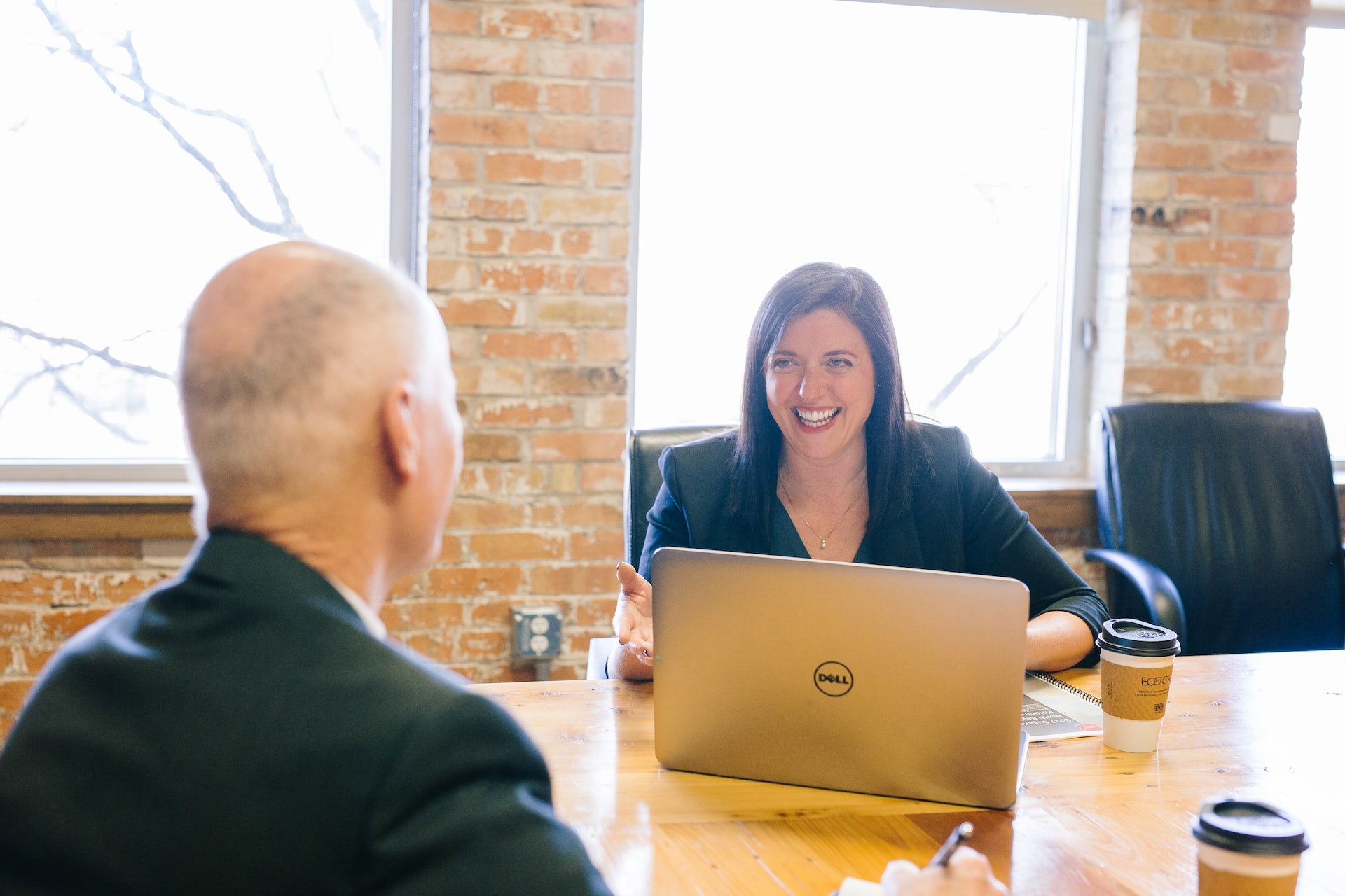 woman-and-a-man-in-a-client-meeting-talking-with-a-laptop-and-coffee