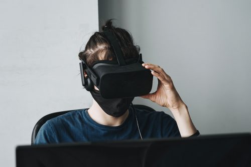 man-using-an-AR-headset-sitting-at-a-computer