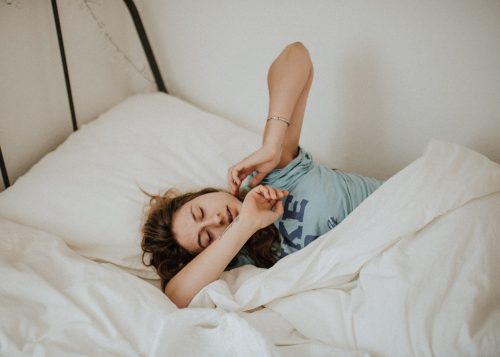 woman-in-bed-awaking-from-a-restful-sleep