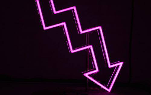 image-of-a-large-pink-neon-sign-jaggedly-pointing-downwards
