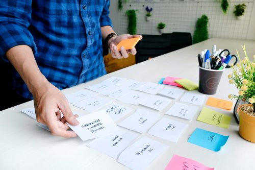 image-of-a-person-laying-out-post-it-notes-deep-into-the-development-process