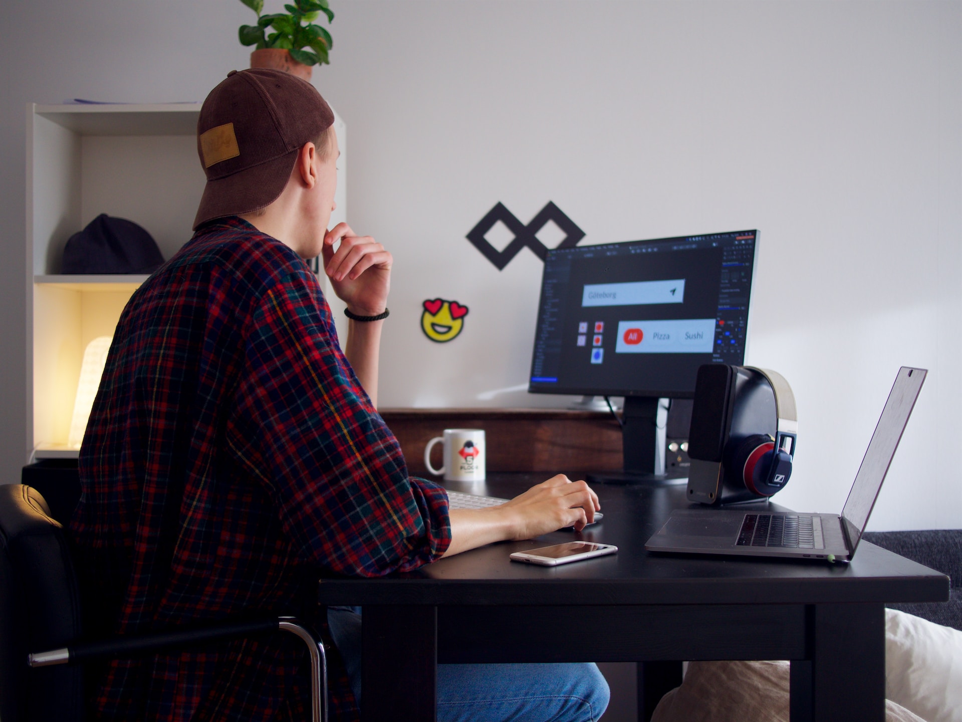 shot-from-behind-of-a-man-sitting-at-a-computer-at-home-working