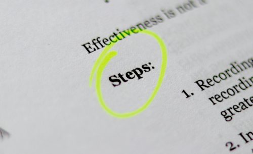close-up-shot-of-a-document-with-the-word-steps-circled-in-yellow-highlighter