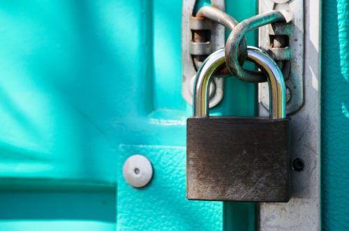 close-up-shot-of-a-padlock-securely-fastening-a-door-closed