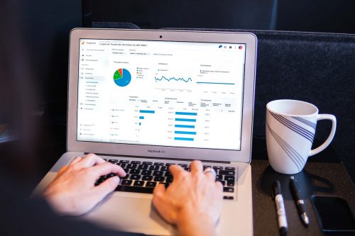 over-the-shoulder-shot-of-someone-analysing-data-on-a-computer