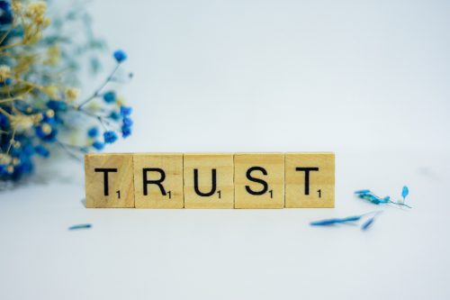 scrabble-tiles-sitting-on-a-desk-spelling-out-the-word-trust