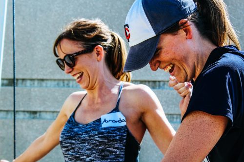 two-women-smiling-and-laughing-while-taking-part-in-an-activity