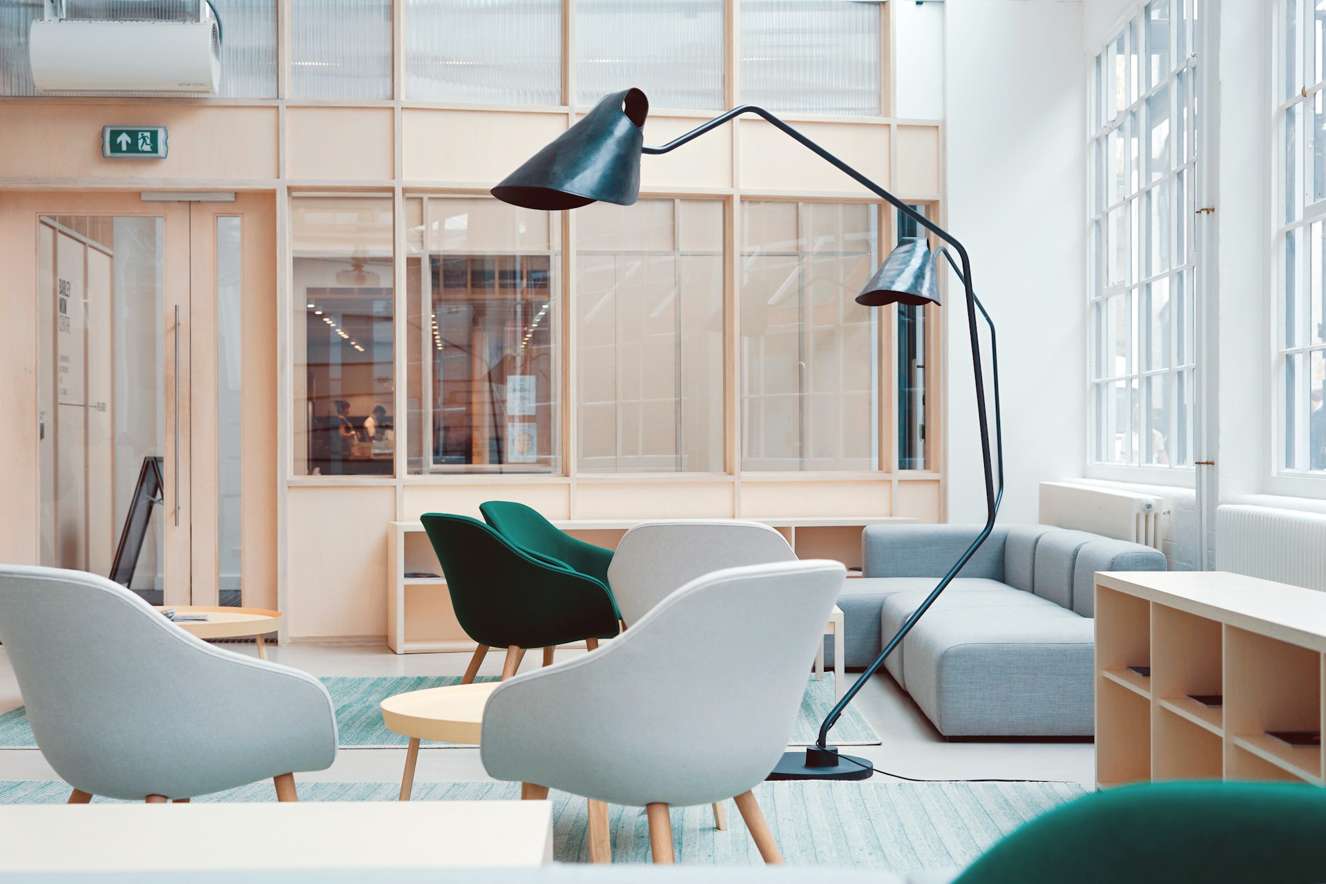 shot-of-a-bright-office-with-metal-lamps-and-grey-and-green-chairs-in-a-seating-area