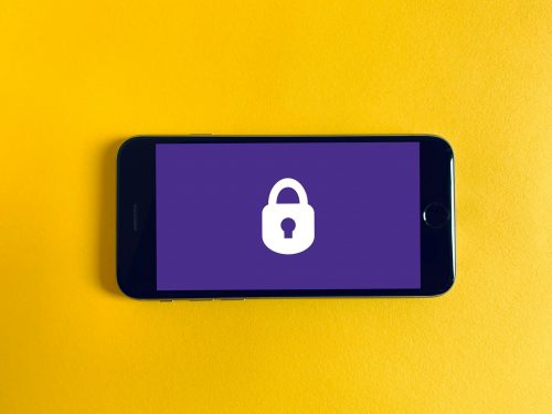 smartphone-displaying-a-padlock-with-a-purple-background-on-a-yellow-background